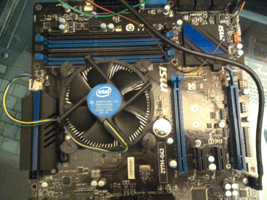 The fan is over the CPU and attached to the motherboard.