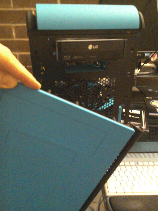 Blu-ray burner attached to the front of the case with its top open.