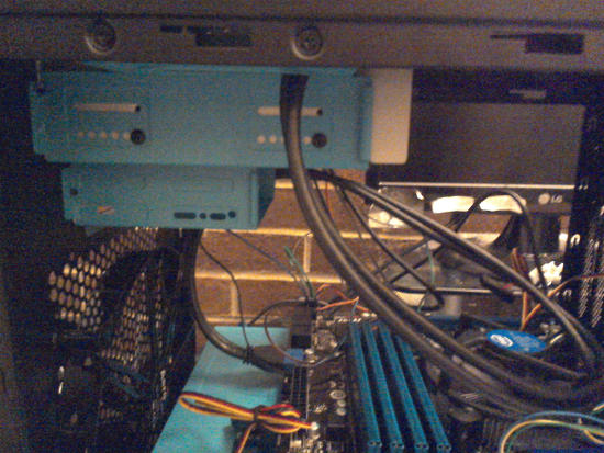 Two blue internal drive trays inside the case, the top is bigger than the bottom one.  Both are located on the higher part of the case.  The top case has screws on the side to hold the Blu-ray burner.