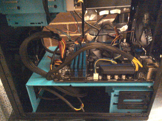 Thick power cables going through the bottom of the motherboard floor and attaching to the motherboard.