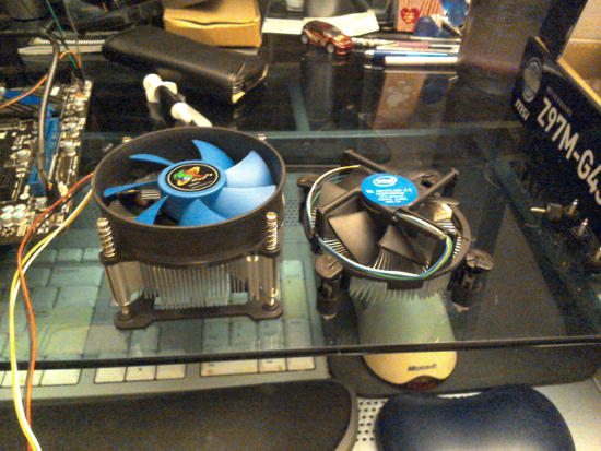 Two blue processor fans side-by-side, both blue.  The left one is taller than the right one.
